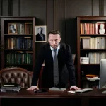 businessman in his office looking at the camera