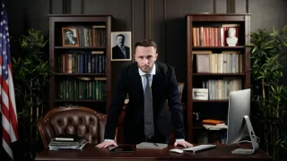 businessman in his office looking at the camera