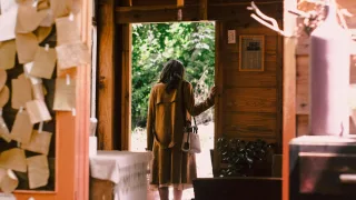 woman standing near open door about to step outside